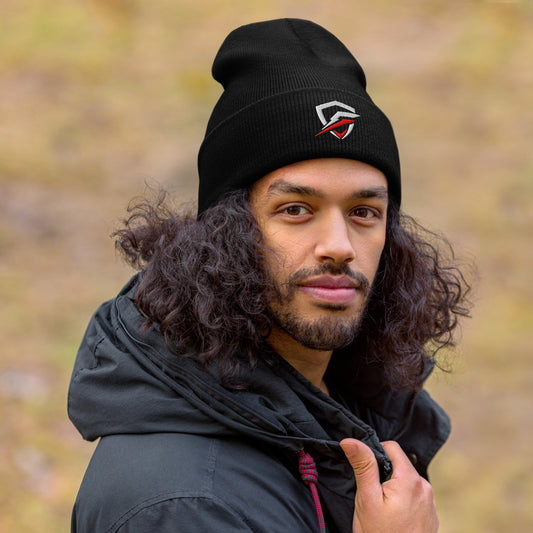 GT Beanie worn by a brown male with curly brown hair, wearing a black jacket and looking into the camera