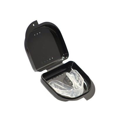 Clear mouthguard in a black case on a white background