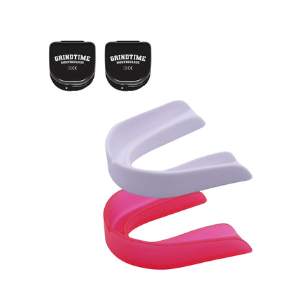 Two GT Performance Mouthguards, white and pink, with two black cases in the left upper corner